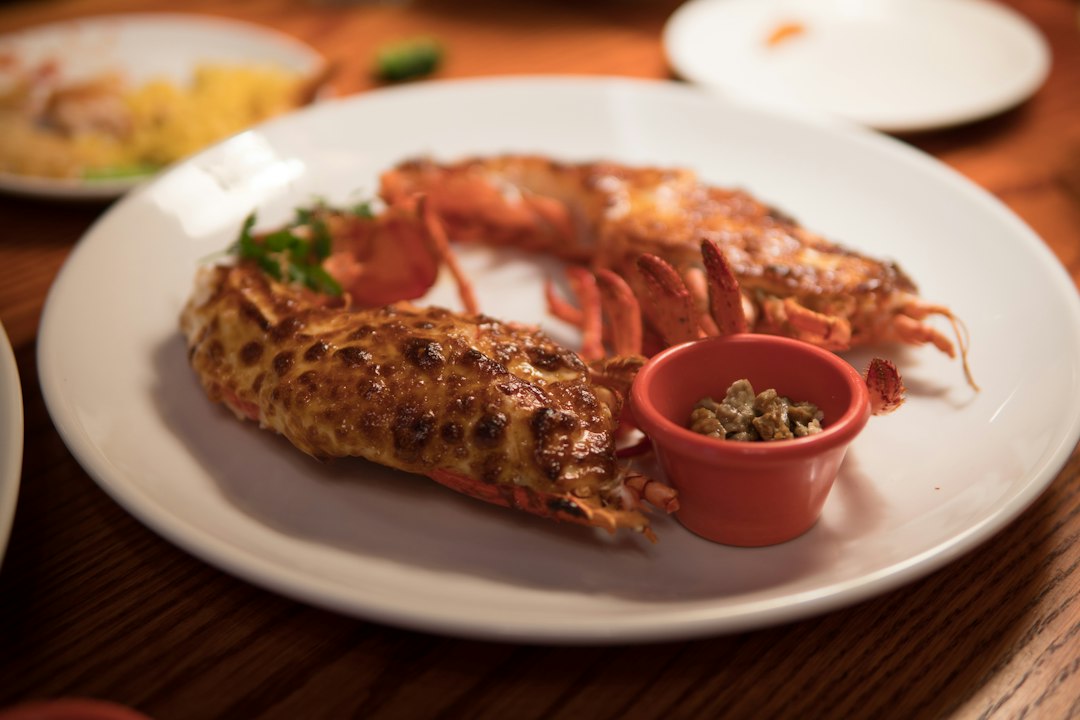 Grilled lobster tail on a plate.