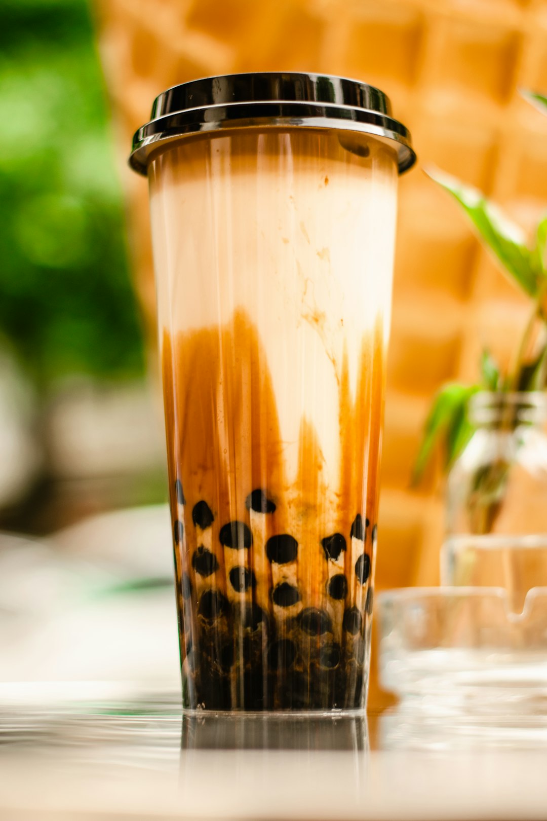 Cup of bubble tea in a clear plastic container.