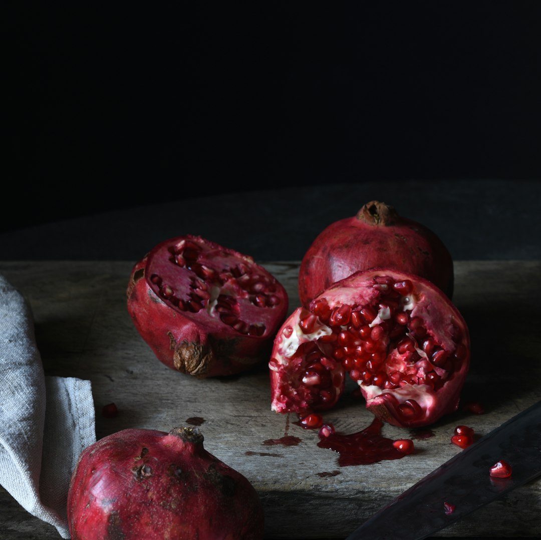 Group of pomegranates on a table.