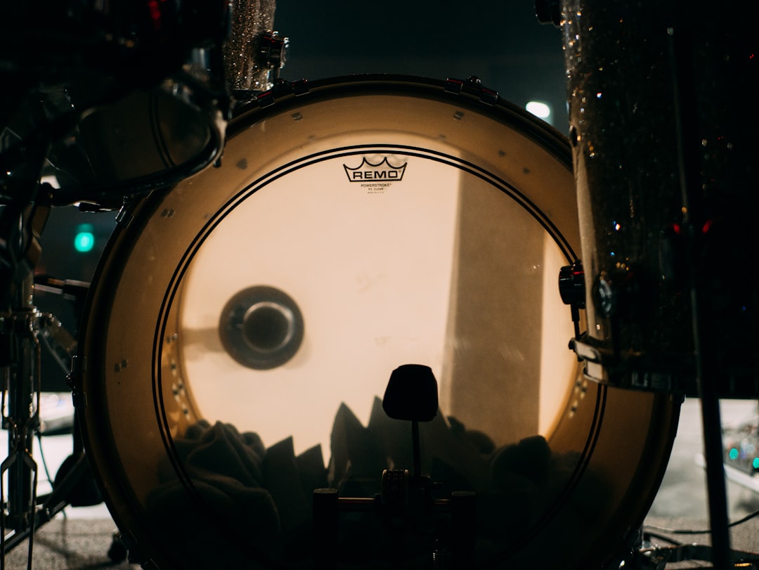A marching bass drum, viewed head-on, flaunting its expansive drumhead.
