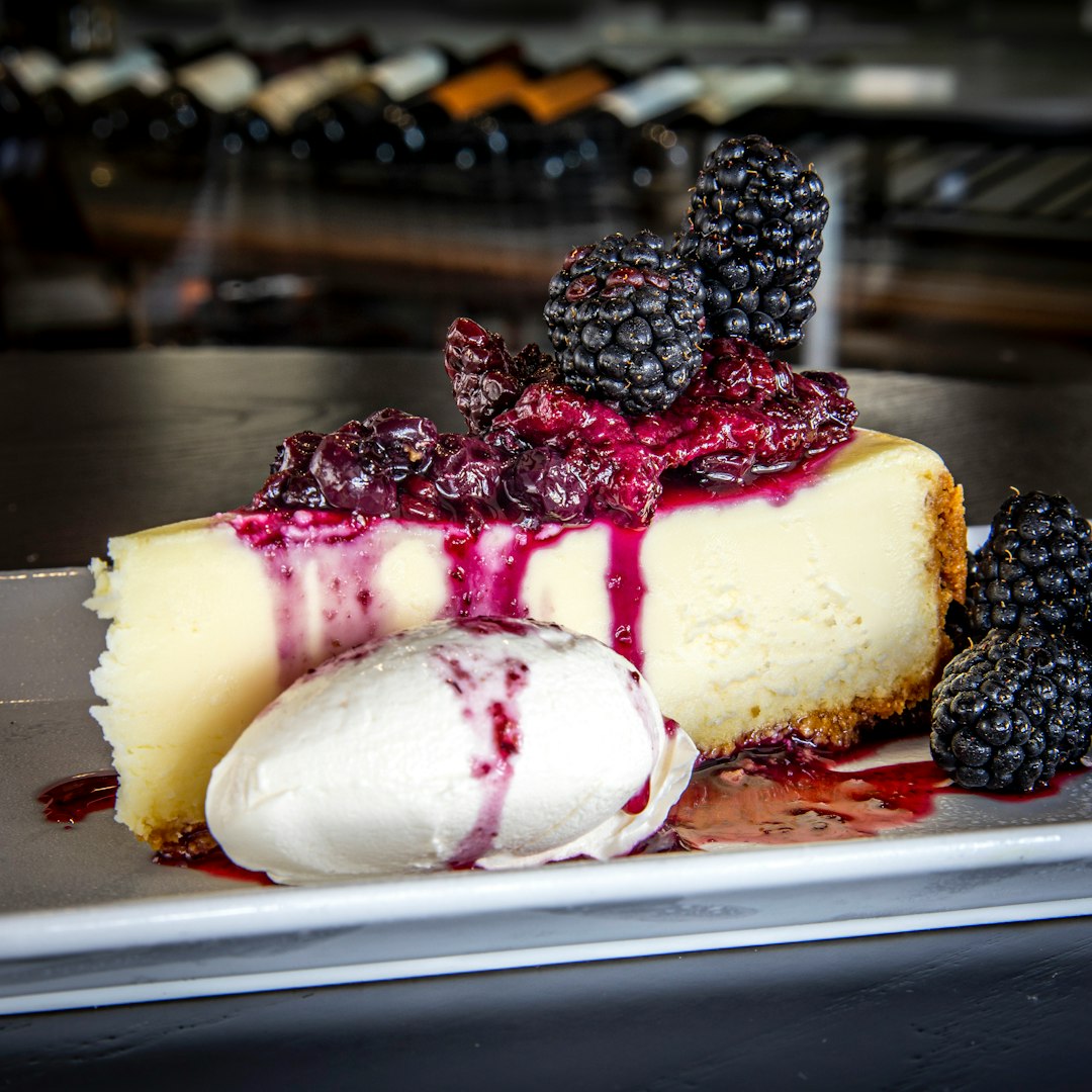 A thiccc specimen of New York cheesecake, clad in blueberry regalia.