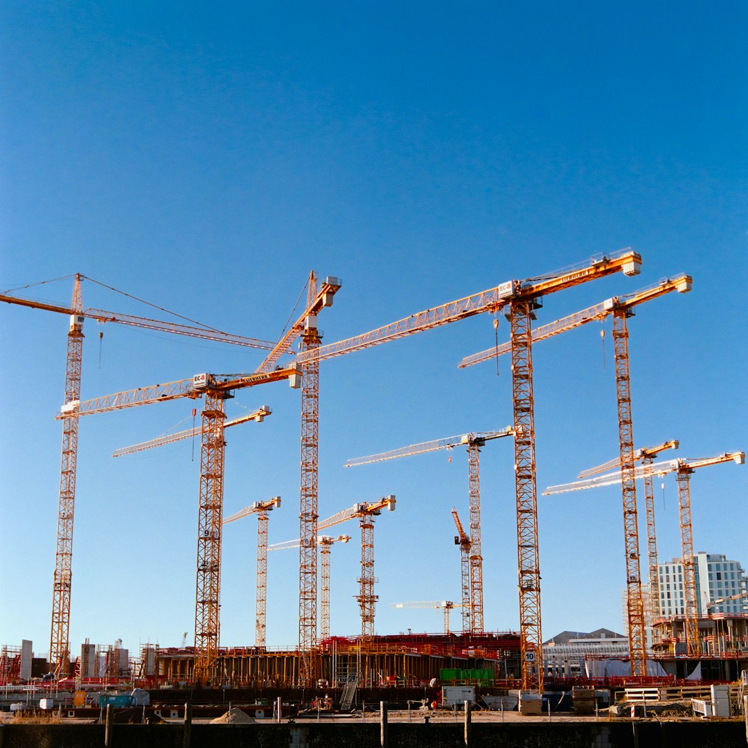 A tower crane in its natural habitat, surveying the urban jungle.