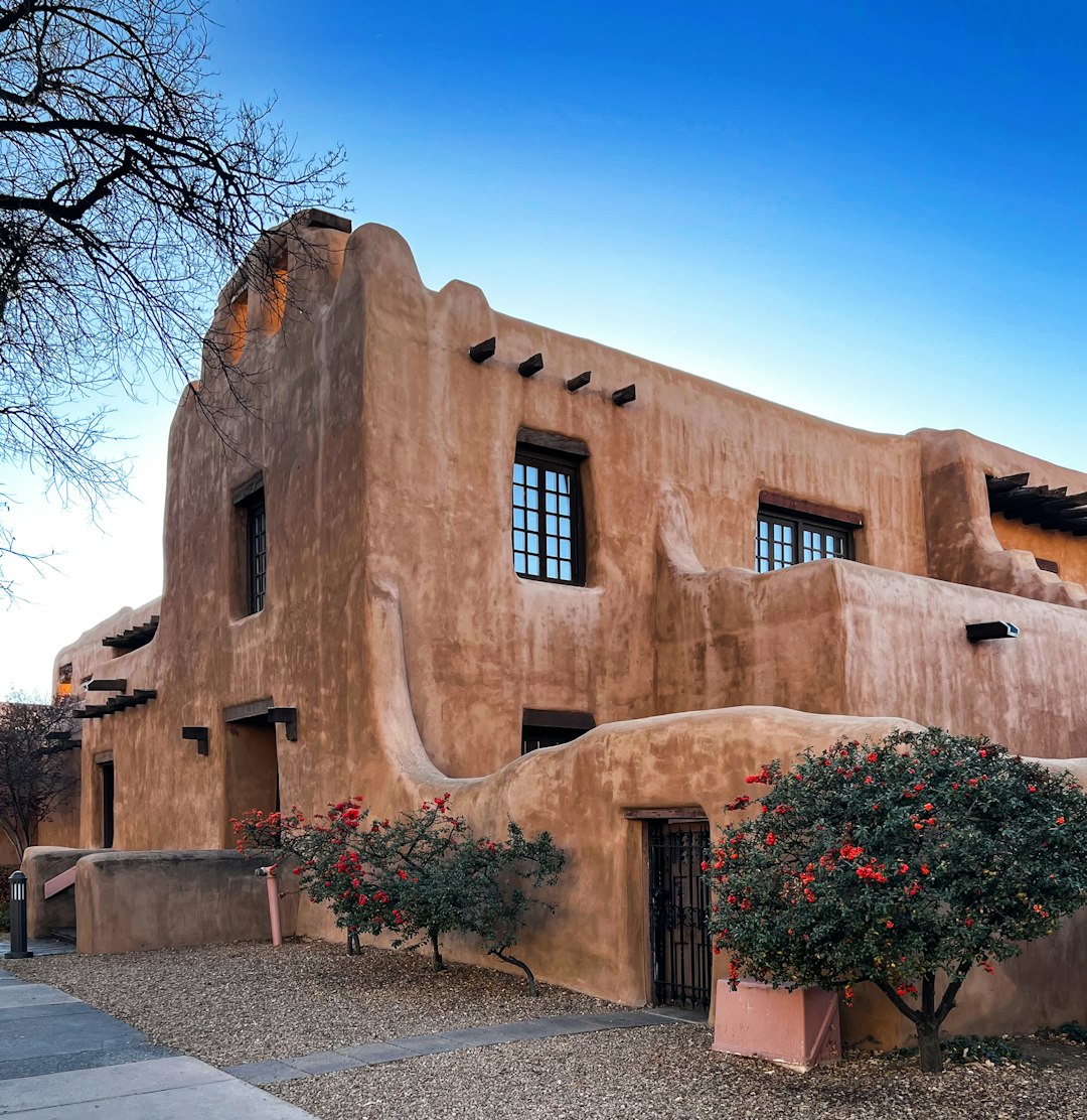 An adobe building, its thiccc walls embracing the floral embellishments.