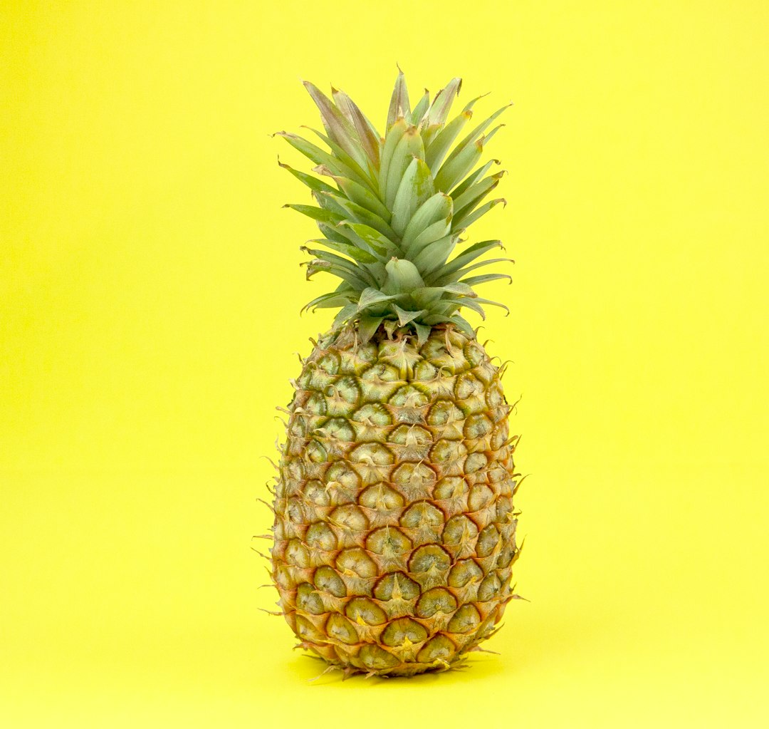Pineapple on a yellow surface.