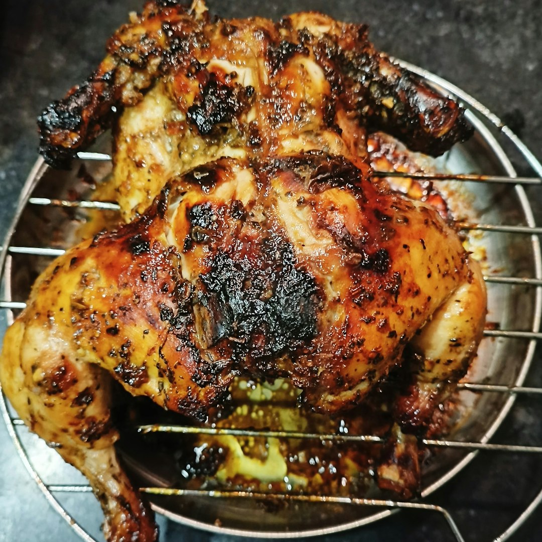 Roast chicken on a metal rack.
