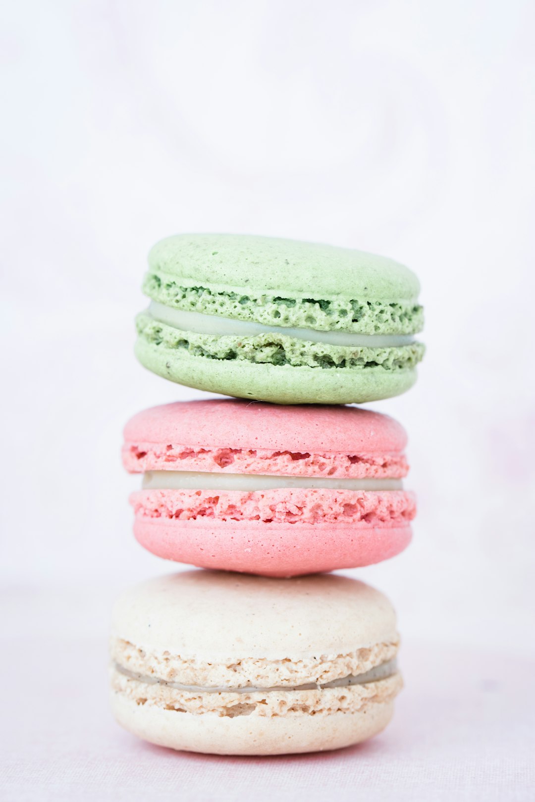 Stack of three assorted-flavor macarons.