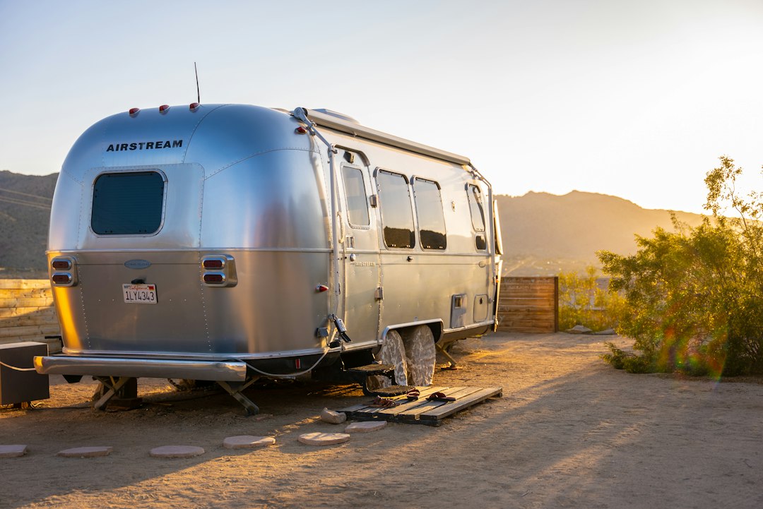 Airstream trailer parked in a desert setting.