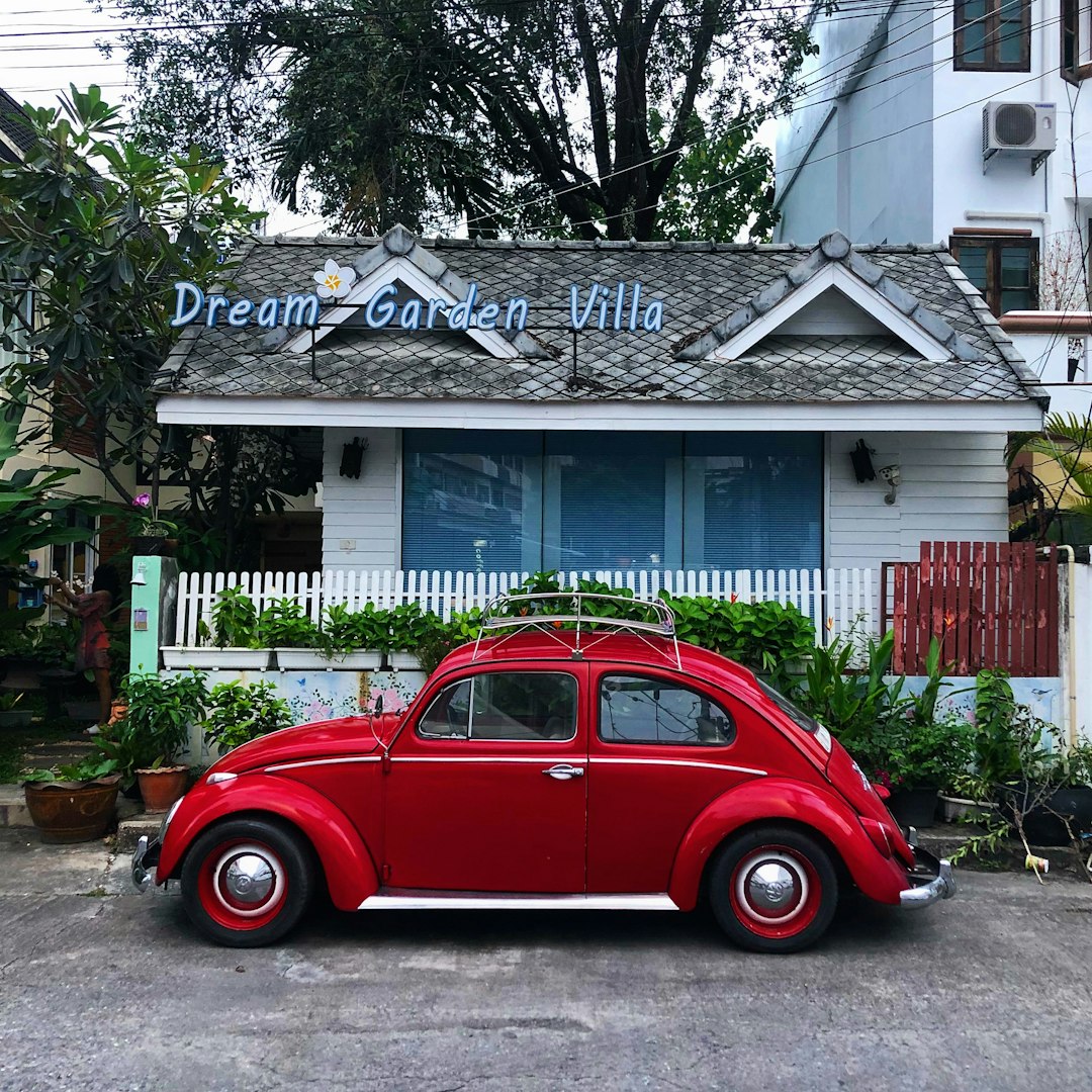 Volkswagen Beetle parked in front of a villa.