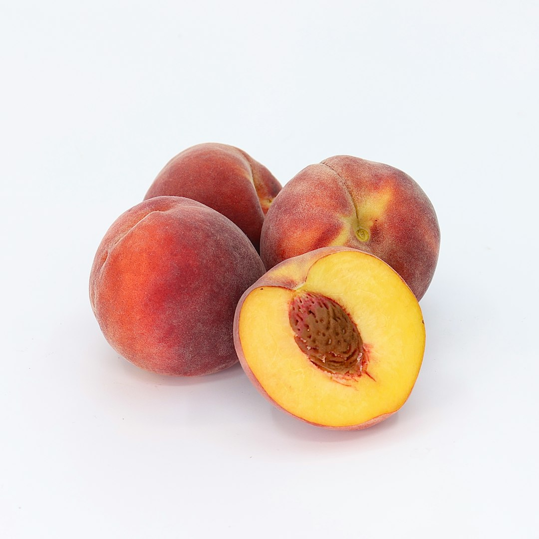 Group of peaches with one cut open.