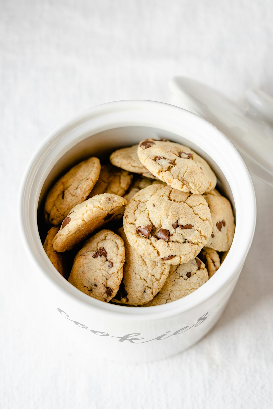 Cookie jar filled with chocolate chip cookies.