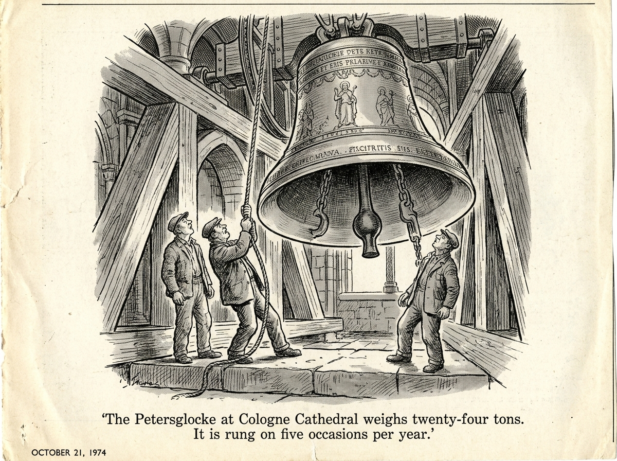 Two bellringers in a cathedral bell chamber dwarfed by a bronze bell the size of a Volkswagen Beetle